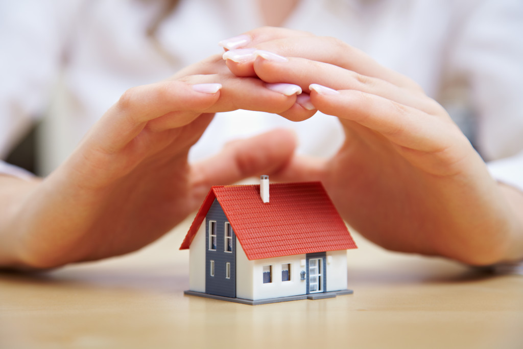 small house and a hand on top of it