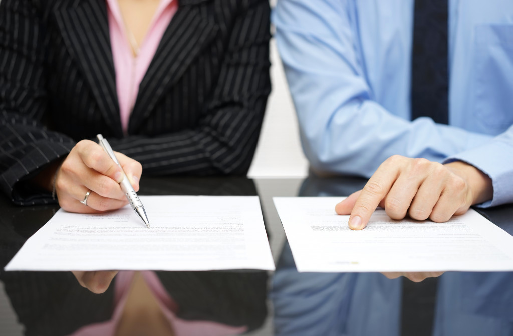 Two people reading a document