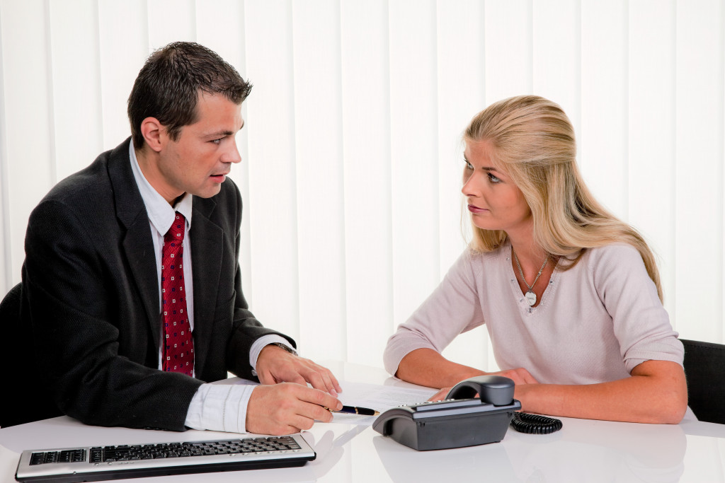 A woman consulting a lawyer in the office regarding a contract