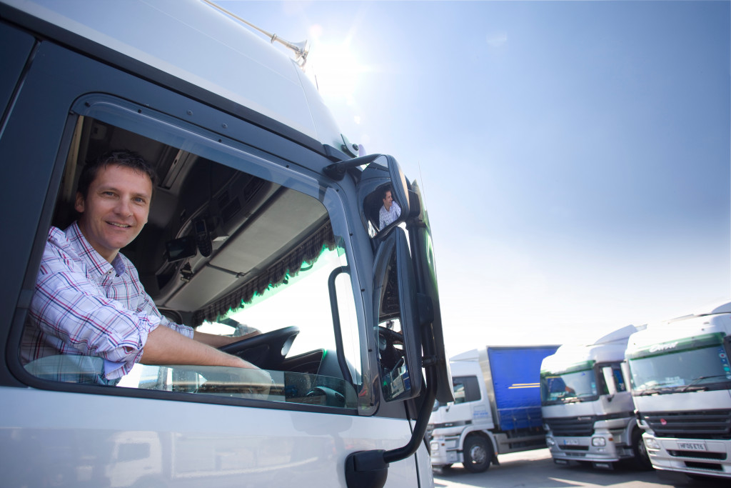 a male truck driver on a truck parking space