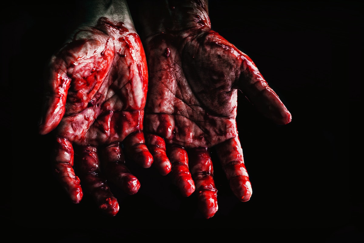 Person's Hands Covered with Blood