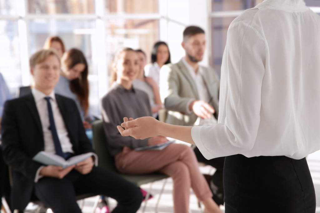 employees in training with speaker presenting